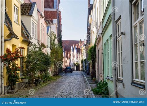 Beautiful Cozy Courtyard With Old Houses And Flowers In The Street Of