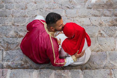 High Angle Photo Of An Arab Man Kissing His Muslim Girlfriend On The Forehead While They Are