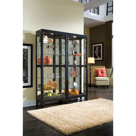 It features three glass shelves (not adjustable,) a mirrored back, and aged brass tone pendant pulls. Pulaski Curio Cabinet & Reviews | Wayfair