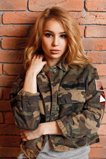 Premium Photo Beautiful Woman In Military Stylish Jacket Near Brick Wall