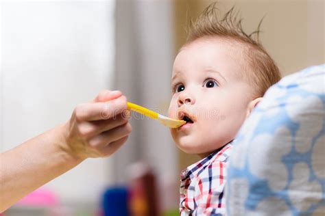 Happy Baby Eating Porridge With Spoon Stock Image Image Of Eating