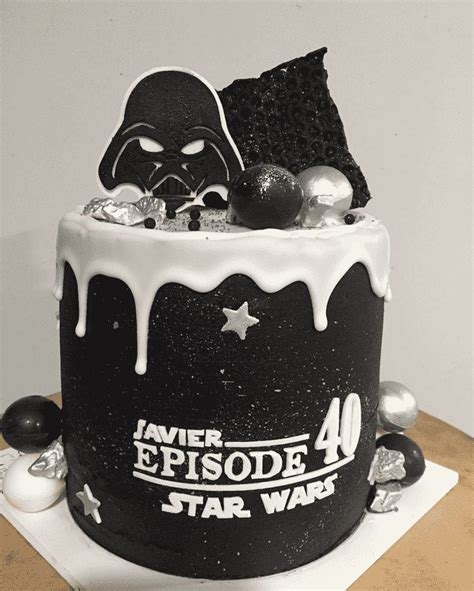 a star wars themed cake with white icing and black frosting on the top