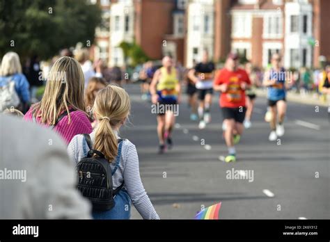 Spectators Cheering On Runners Taking Part In The Great South Run Held In The Streets Around
