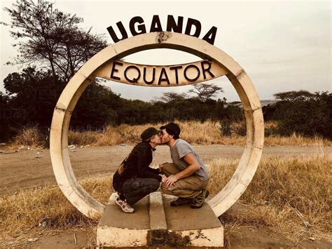 Uganda Couple Kissing At The Equator Stock Photo