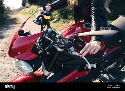 From Above Low Angle Of Brutal Female Biker Sitting On Motorbike On