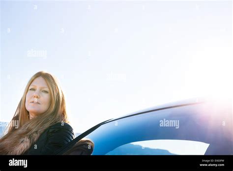 Woman Leaning On Car Stock Photo Alamy