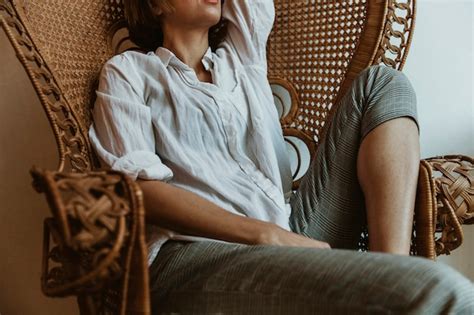 Premium Photo Woman Relaxing On A Vintage Wicker Chair