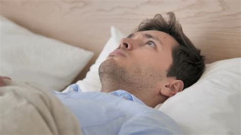 Uncomfortable Man Waking Up From Sleep In Bed Stock Footage Videohive