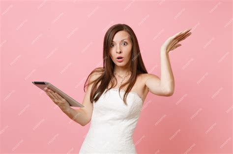 Premium Photo Shocked Concerned Woman In White Dress Spreading Hands