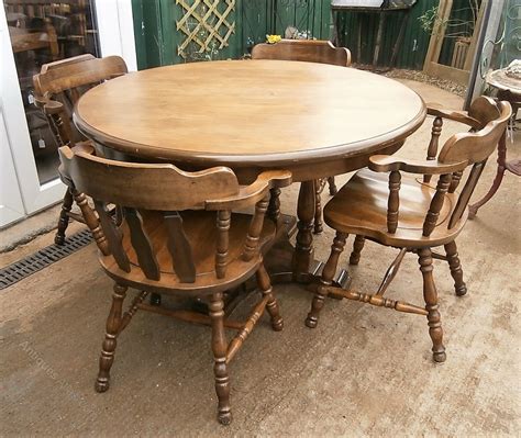 Order this 2 in 1. Antiques Atlas - Vintage Oak Round Table & 4 Captains Chairs.