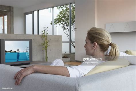 Woman Relaxing On Sofa Watching Television Rear View Photo Getty Images