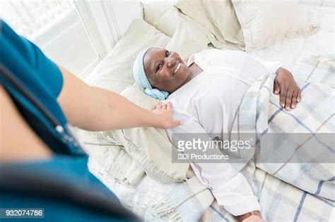 Unrecognizable Nurse Checks On Senior Patient High Res Stock Photo