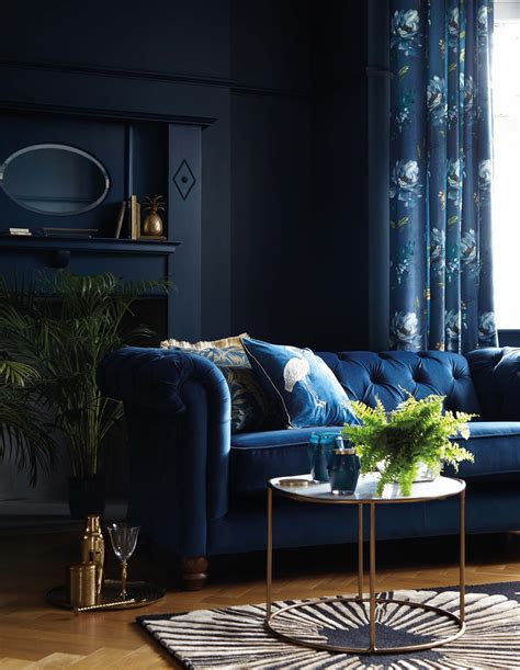 Navy Blue Velvet Sofa And Navy Walls In A Living Room Blue Velvet Sofa