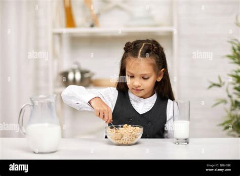 Smiling Cute Little Girl In School Uniform Having Breakfast Cereal