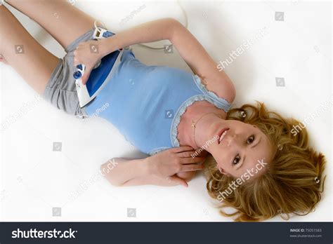 Attractive Blond Woman Lying On The Floor With A Clothing Iron On Stomach As If Ironing It To