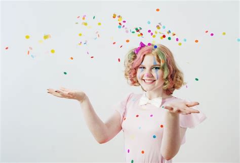 premium photo clown girl blows confetti from hands