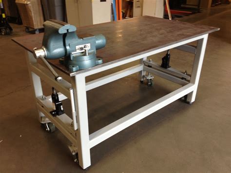 Workbench With Retractable Wheels A Pair Of Hydraulic Jacks And Some