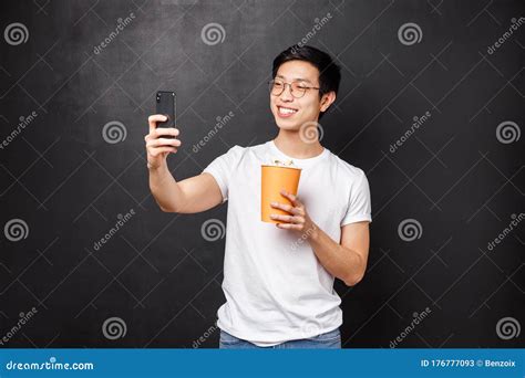 Portrait Of Handsome Cheerful Young Asian Male Blogger Record Video Of