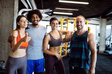 Happy Fit Friends Exercising Working Out In Gym To Stay Healthy