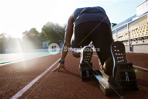 Young Man In Starting Position On Sports Track Royalty Free Stock Image