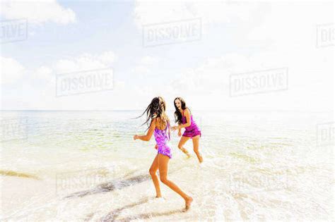 Girl And Her Mom Enjoying Themselves On Beach Stock Photo