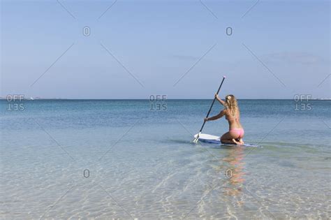 View Of One Girls In Bikini Paddling On A Stand Up Paddle Board Stock