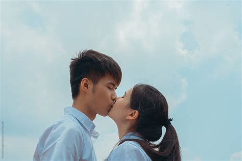 Young Asian College Couple Kissing By Stocksy Contributor Pansfun