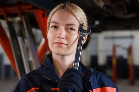Premium Photo Portrait Of A Young Female Car Mechanic In Uniform Who