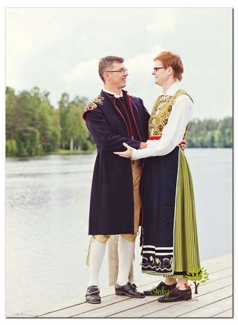 Two People Standing Next To Each Other On A Dock