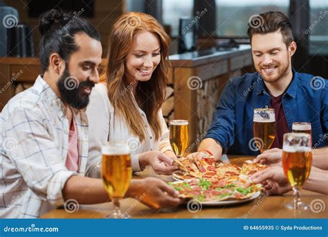 Friends Eating Pizza With Beer At Restaurant Stock Image Image Of