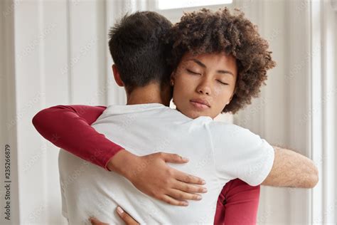 friendly mixed race brother and sister embrace each other support in difficult life situation