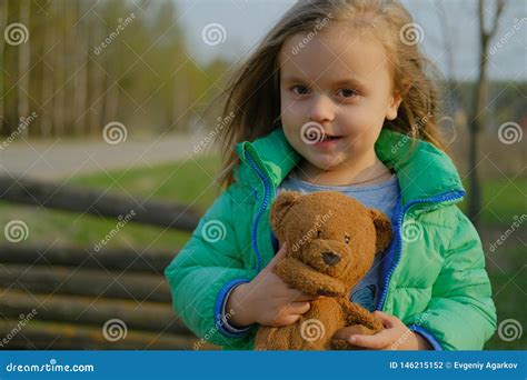 Smiling Baby Girl Holding Teddy Bear Outdoors Stock Photo Image Of