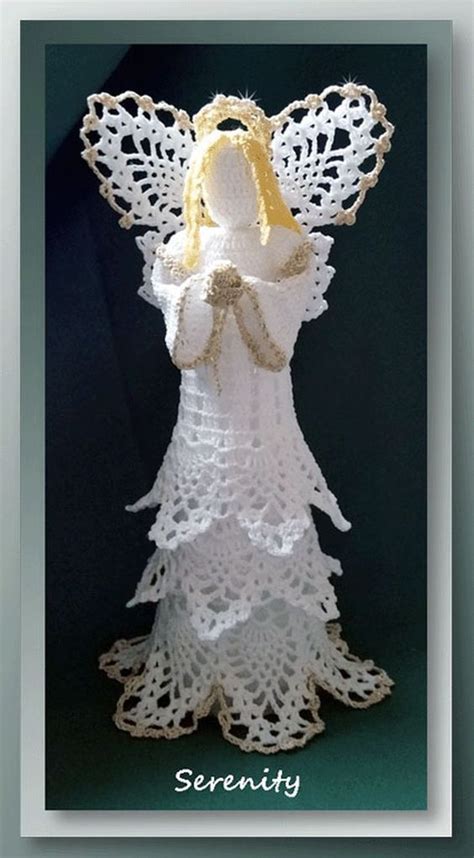 A White Crocheted Angel With A Yellow Ribbon On Its Chest And Wings