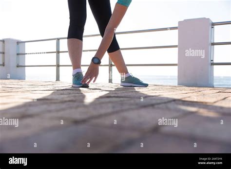 Female Jogger Stretching On Seaside Stock Photo Alamy