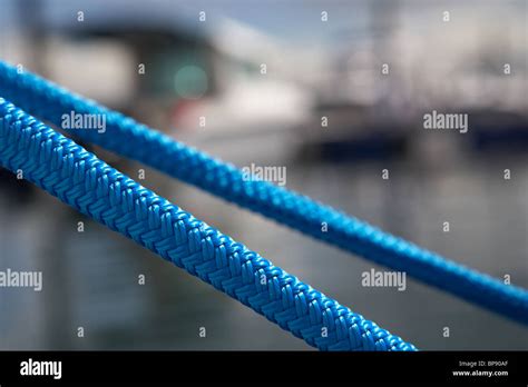 Taught Tight Blue Mooring Ropes In A Marina In The Uk Stock Photo Alamy