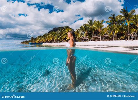 Woman Posing In Transparent Blue Ocean Swimming In Blue Water At