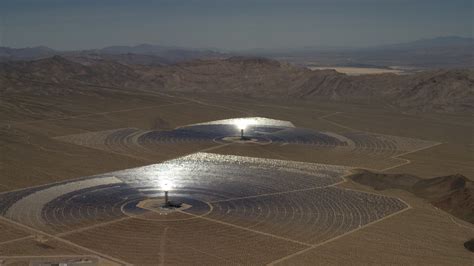 4k Stock Footage Aerial Video Of Two Of The Mirror Arrays And Power Towers At The Ivanpah Solar