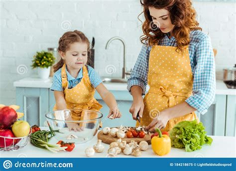 Cute Daughter Helping Mother Cooking Vegetables Stock Image Image Of
