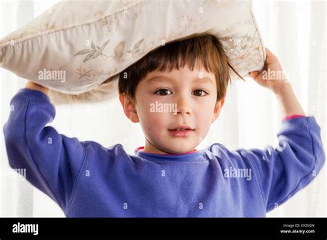 Caucasian Child Boy 6 7 Year Old Using Hands To Balance Cushion On