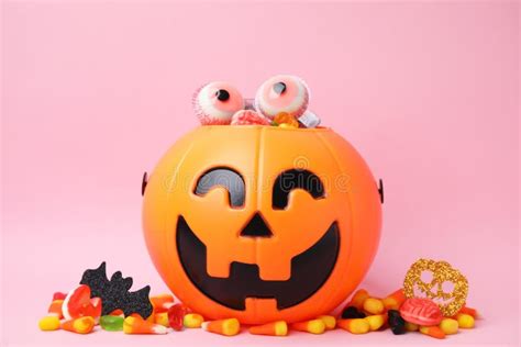 Halloween Trick Or Treat Bucket With Different Sweets On Pink