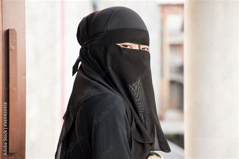 Portrait Of Arabian Woman Looking At You While Covering Her Face With