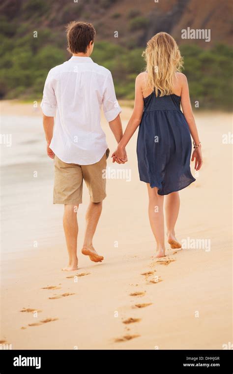 Romantic Happy Couple Walking On Beach At Sunset Smiling Holding Hands Man And Woman In Love