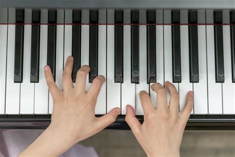 Children S Hands Are Playing The Piano Child S Hand On Piano Keys