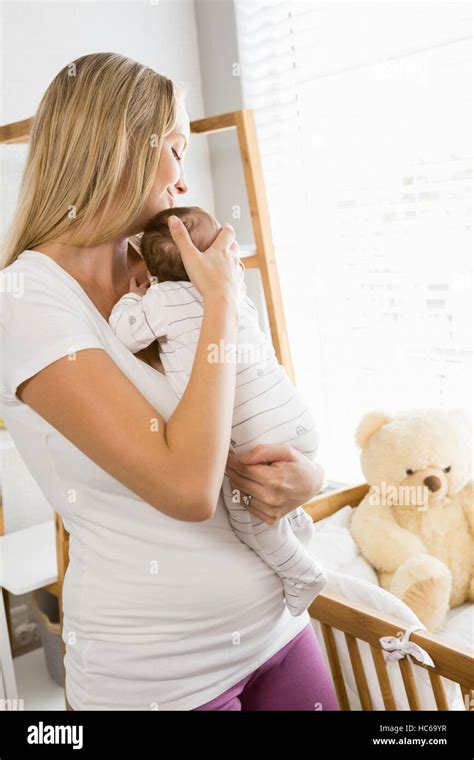 Smiling Mother Carrying Her Baby Stock Photo Alamy