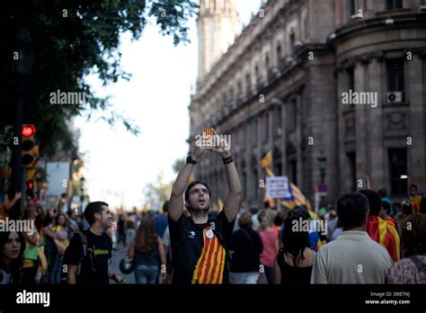 Man With A Catalan Flag On The T Shirt Taking A Picture With A Cellular