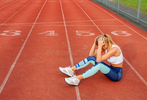 Tired Woman Runner Taking A Rest After Run Sitting On The Running Stock