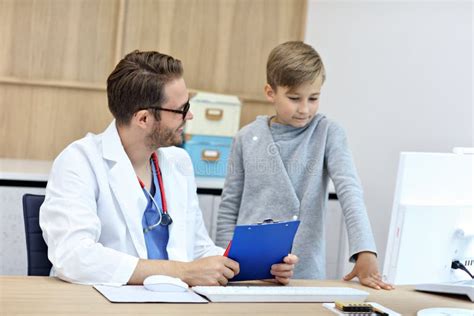 Little Boy In Clinic Having A Checkup With Pediatrician Stock Image