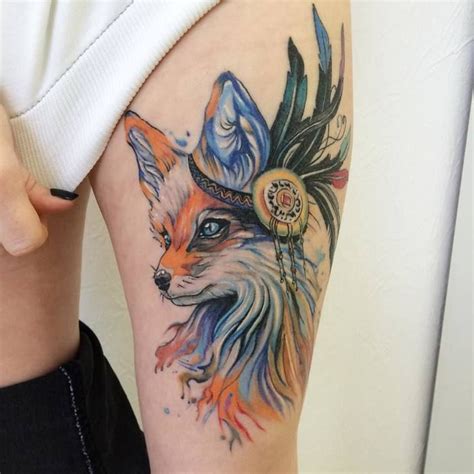 A Womans Arm With A Tattoo On It And A Fox Wearing A Feather Headdress