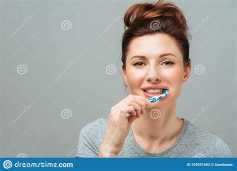 Woman With Healthy White Teeth Holds A Toothbrush And Smiles Oral