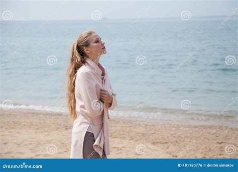 Beautiful Blonde Woman Walks Alone On A Sandy Beach By The Sea Stock Photo Image Of Outdoor
